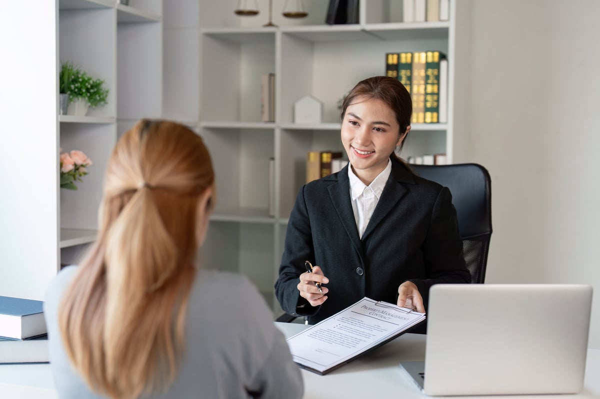 Legal document preparer advising a client in a modern office