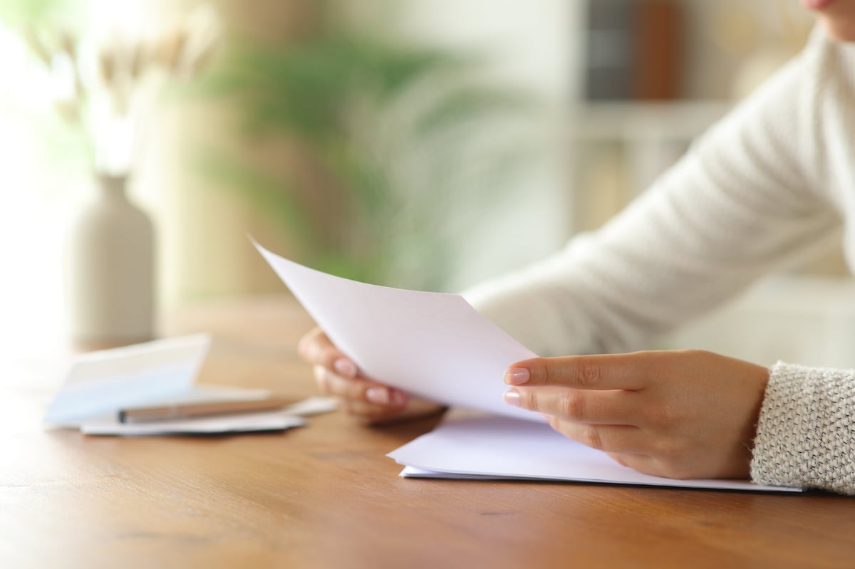 Person reviewing family law documents at a table in a home
